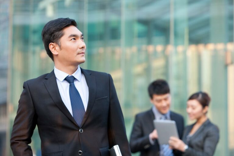 business-people-outside-office-building-2024-10-18-00-12-50-utc