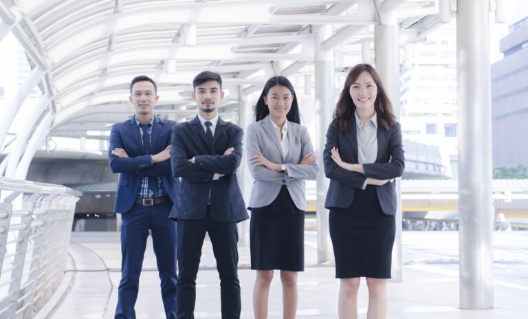 Happy smiling business team standing at outside