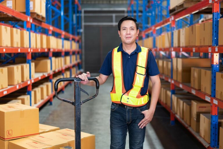 portrait-of-asian-male-worker-with-boxes-on-cart-t-2023-11-27-05-03-22-utc